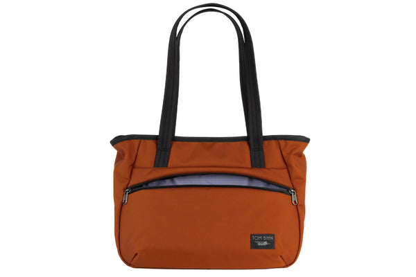 Photo of the Nomad Tote in Burnt Orange Ballistic with Dusk (purplish-blue with dark bluish-purple grid) 210 Cerylon interior.